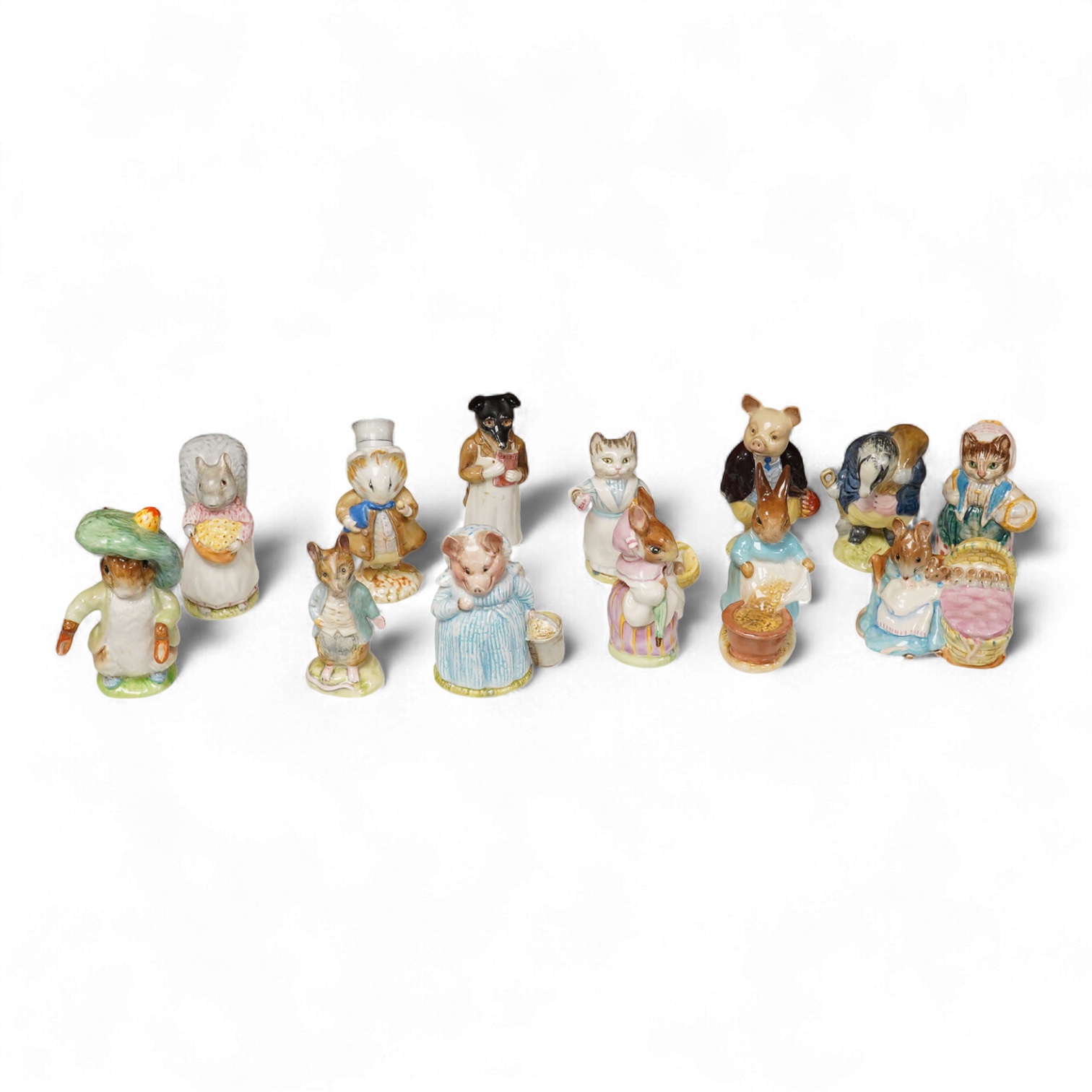A collection of thirteen Beatrix Potter character figures, stamped with a gold stamp F Warn and Co Ltd, Beswick England, largest 12cm high